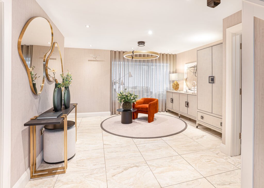 Entrance area with round mirror and orange accent chair – Luxury Living Room Part Two by AK Interior.