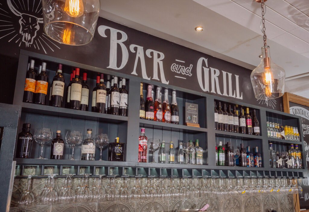 Close-up of ‘Bar & Grill’ wall sign on reclaimed timber planks. Briar Rose Commercial project, AK Interior, Cork.