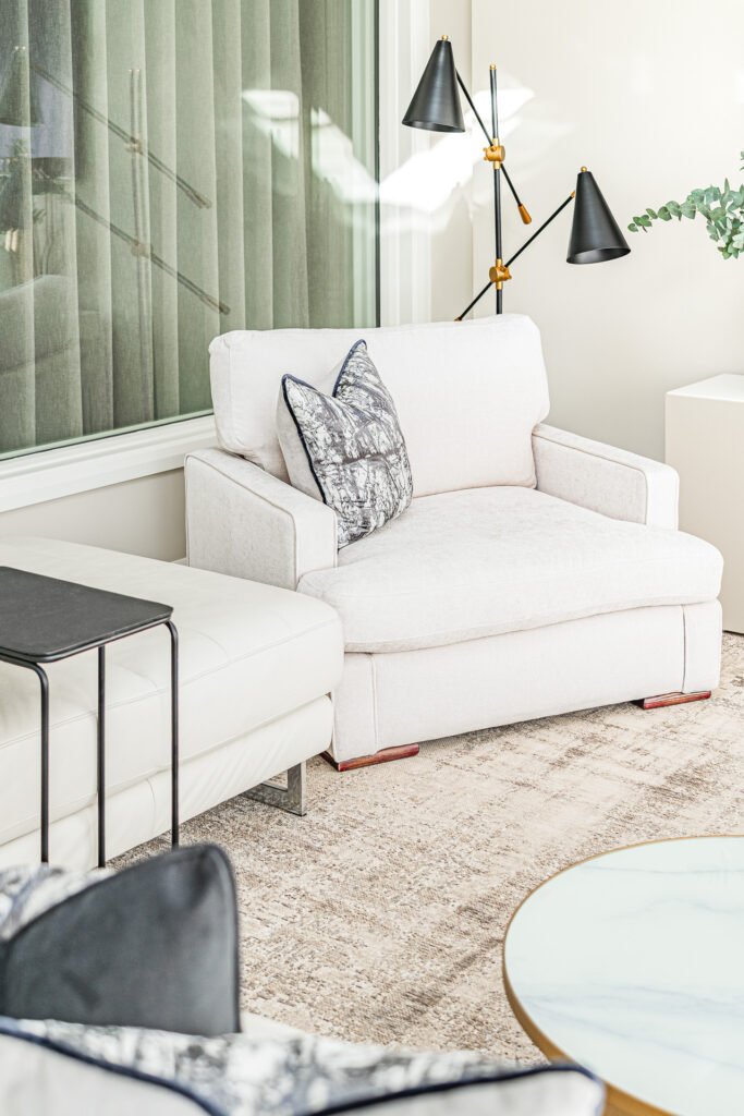 Light armchair with grey decorative cushions in the living room – Moneygurney Road Part One, AK Interior