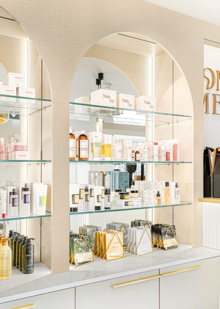 Arched display shelves filled with beauty products under soft ambient lighting – Bon Me project, designed by AK Interior Cork.
