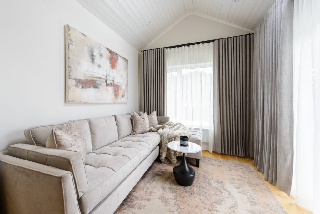Living room with a light sofa and long grey curtains – Whitegate Holiday Home, AK Interior, Cork