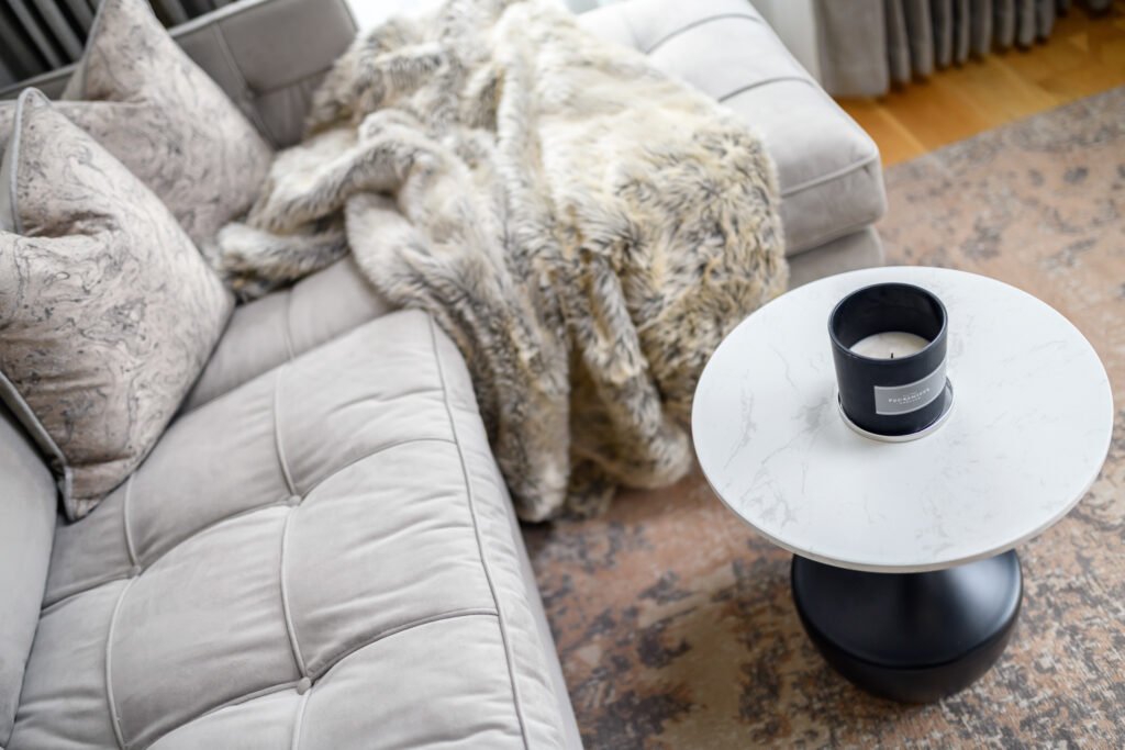 Sofa with a faux-fur throw and round coffee table – Whitegate Holiday Home, AK Interior, Cork