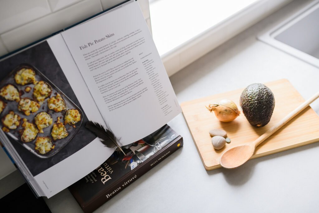 Kitchen countertop with a cookbook and ingredients – Whitegate Holiday Home, AK Interior, Cork