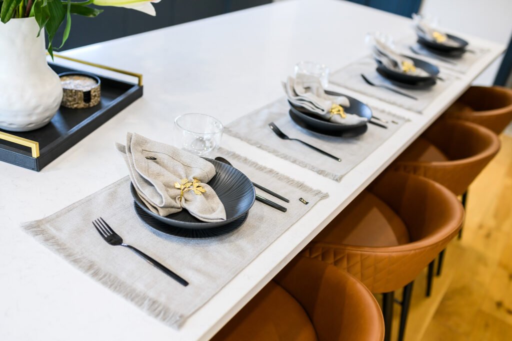 Kitchen island set with plates and brown chairs – Whitegate Holiday Home, AK Interior, Cork