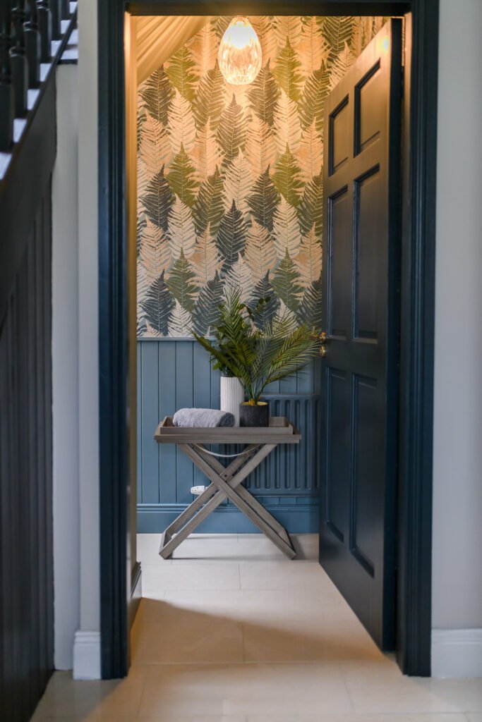 Entryway with patterned wallpaper and a plant on a console table – Whitegate Holiday Home, AK Interior, Cork