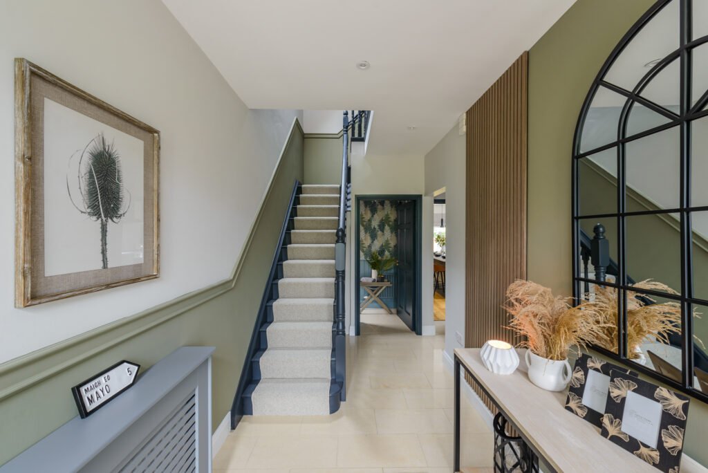 Staircase with green-toned walls and decorative accents – Whitegate Holiday Home, AK Interior, Cork