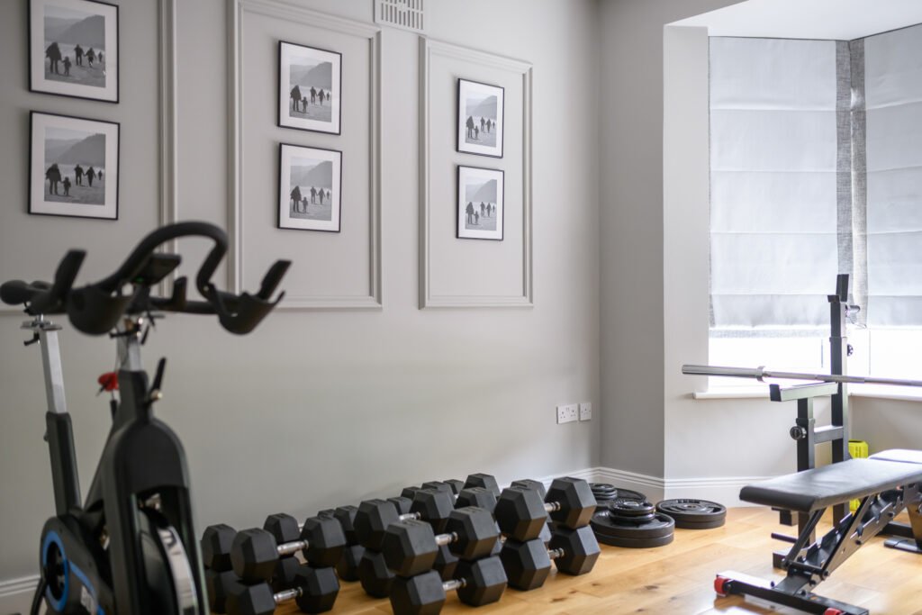 Home gym area with exercise bike, weights, and grey blinds – Whitegate Holiday Home, AK Interior, Cork