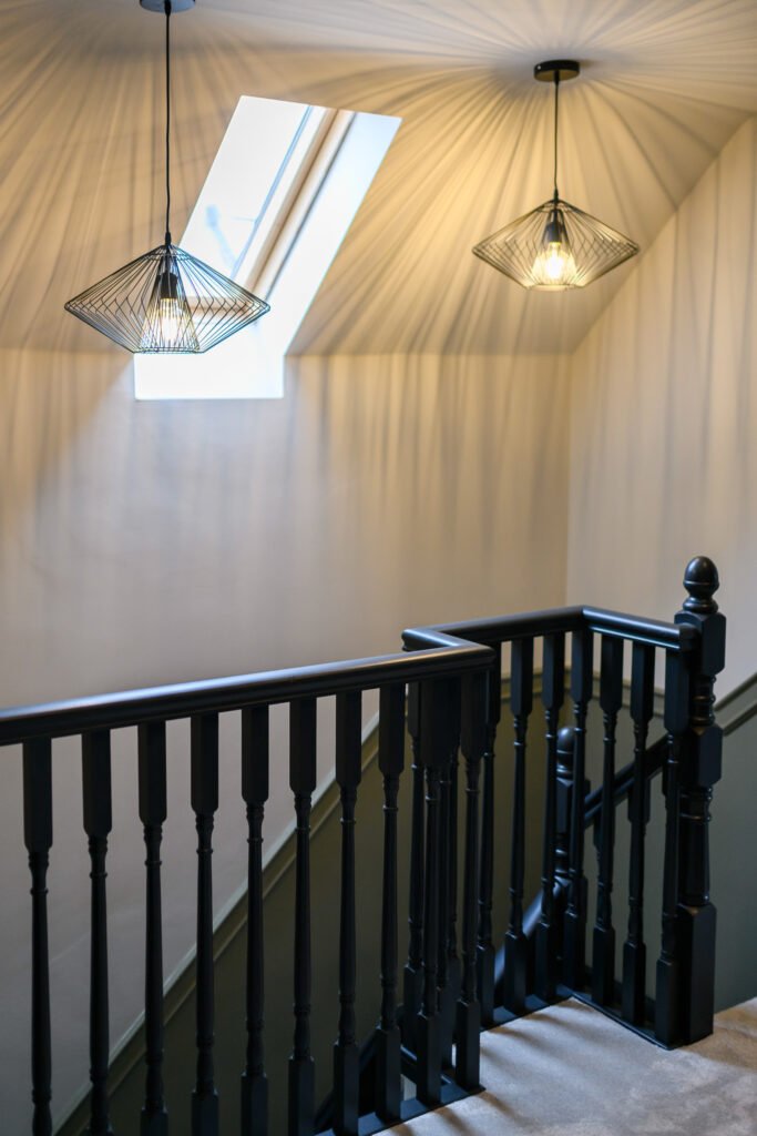 Staircase with two decorative ceiling lights and skylight – Whitegate Holiday Home, AK Interior, Cork
