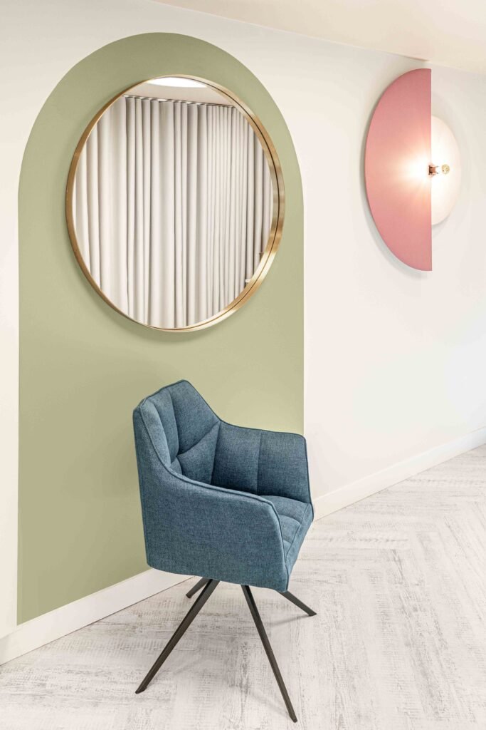 Green arched feature wall with a round mirror and blue accent chair – Bon Me project, designed by AK Interior Cork.
