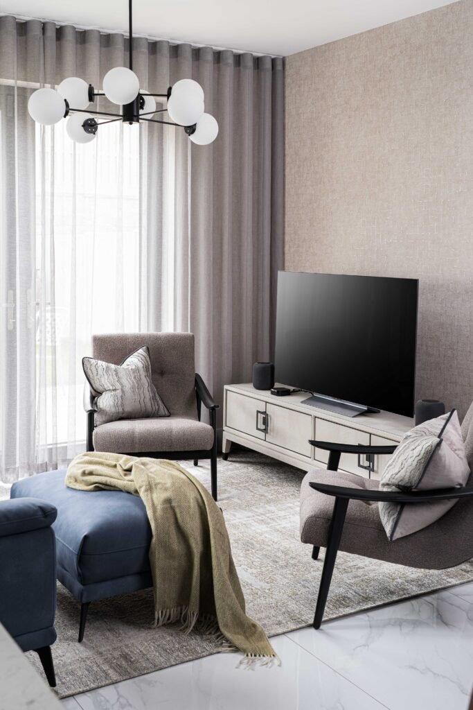 Living room corner with blue sofa, armchair and TV unit – Residential project “The Steeples Part One”, designed by AK Interior, Cork, Ireland.