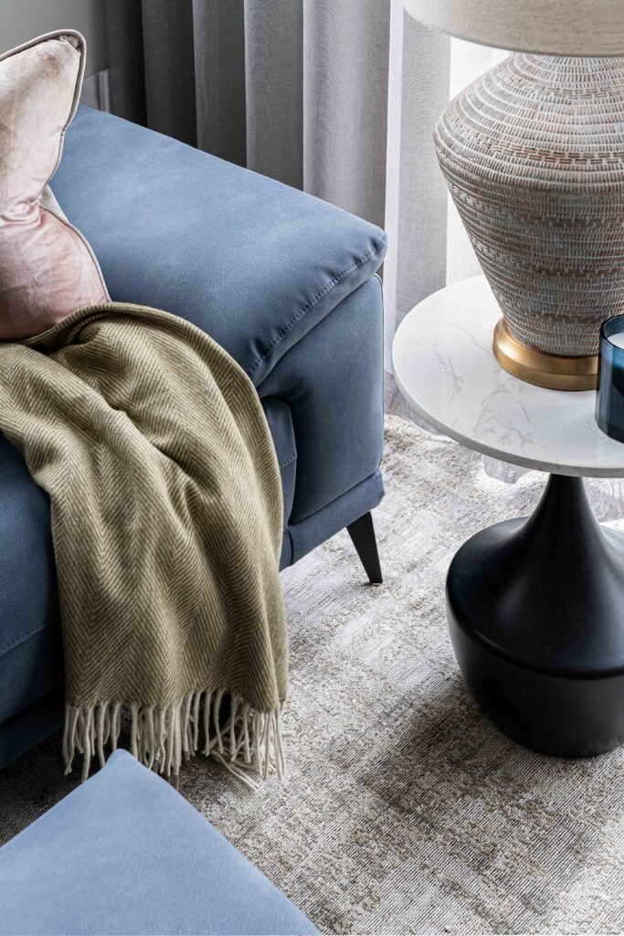 Decorative table lamp on round side table beside blue sofa – Residential project “The Steeples Part One”, designed by AK Interior, Cork, Ireland.