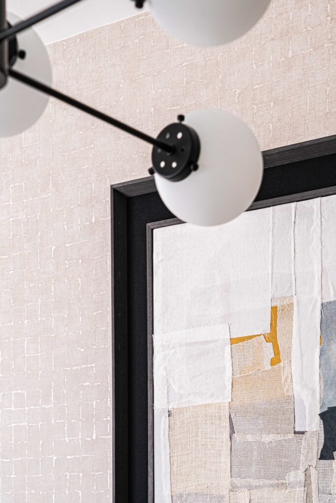 Contemporary chandelier beside textured wall art – Residential project “The Steeples Part One”, designed by AK Interior, Cork, Ireland.