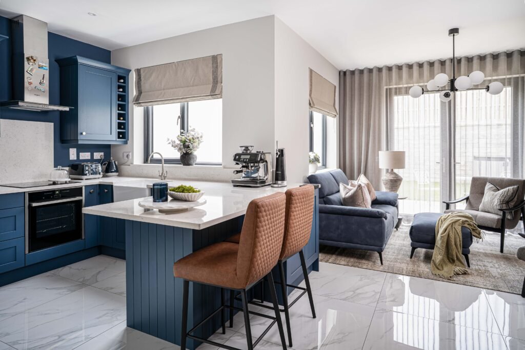Round dining table with soft grey chairs and sculptural chandelier – Residential project “The Steeples Part One”, designed by AK Interior, Cork, Ireland.