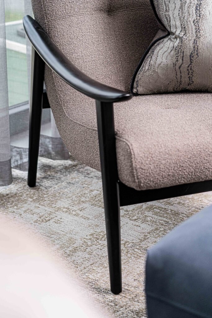 Armchair and footstool by window with neutral-toned table lamp – Residential project “The Steeples Part One”, designed by AK Interior, Cork, Ireland.