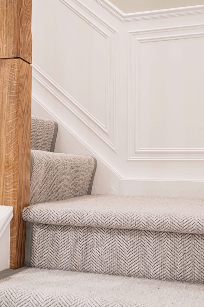 Under-stair detail with soft lighting and decorative trims — The Steeples Part One by AK Interior