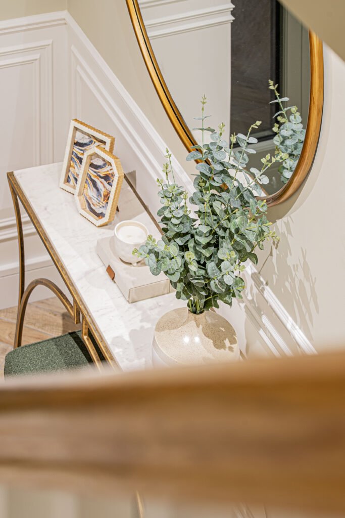 Entryway floral styling with gold-framed mirror and wall mouldings — The Steeples Part One by AK Interior
