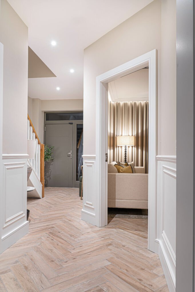 Home hallway with herringbone flooring and styled console table — The Steeples Part One by AK Interior