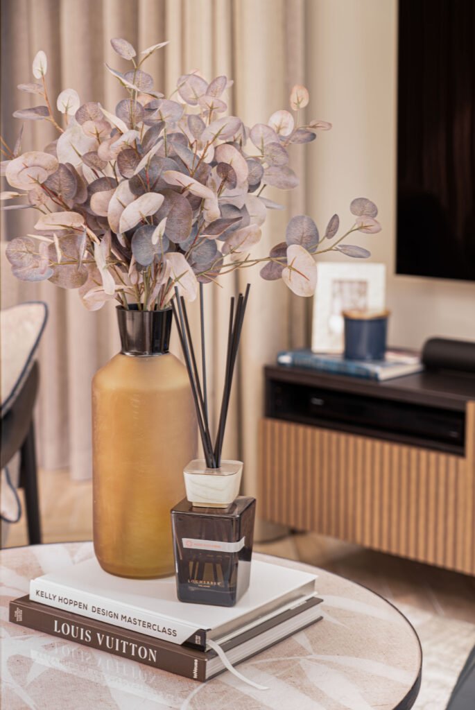 Close-up of dried floral arrangement in ceramic vase on soft furnishings — The Steeples Part One by AK Interior