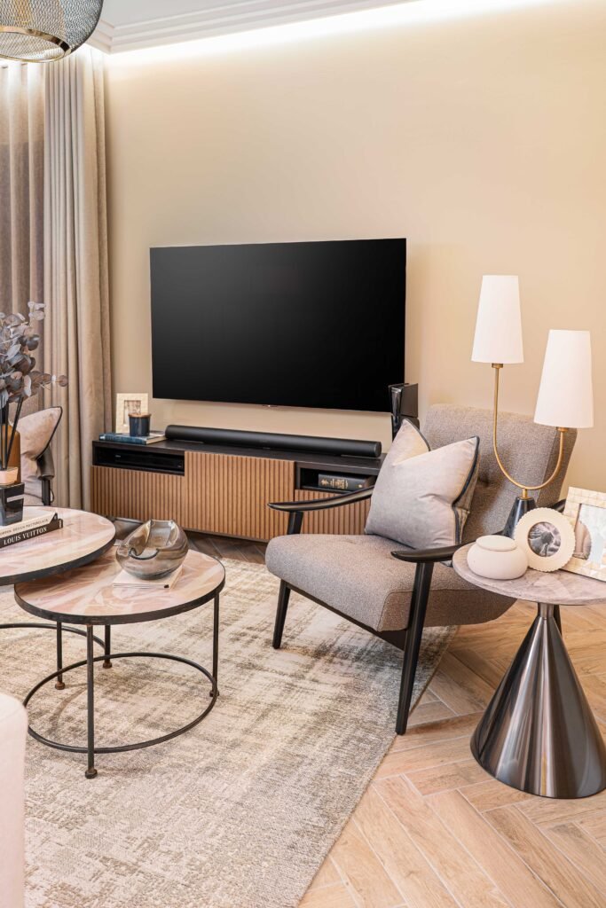 Contemporary family room with grey curtains, TV unit and layered lighting — The Steeples Part One by AK Interior, Cork