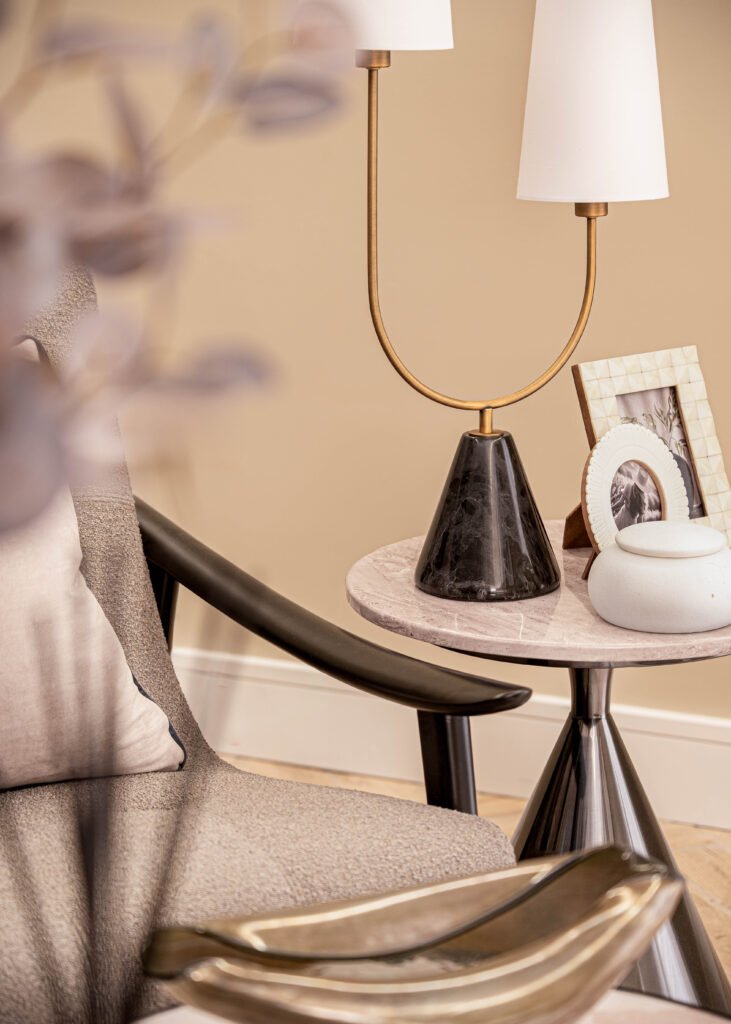 Modern console table with sculpture and accent lighting — The Steeples Part One by AK Interior