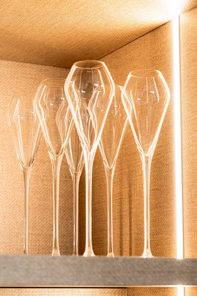 Elegant glassware displayed on an illuminated kitchen shelf | Monkstown Full House Design | AK Interior