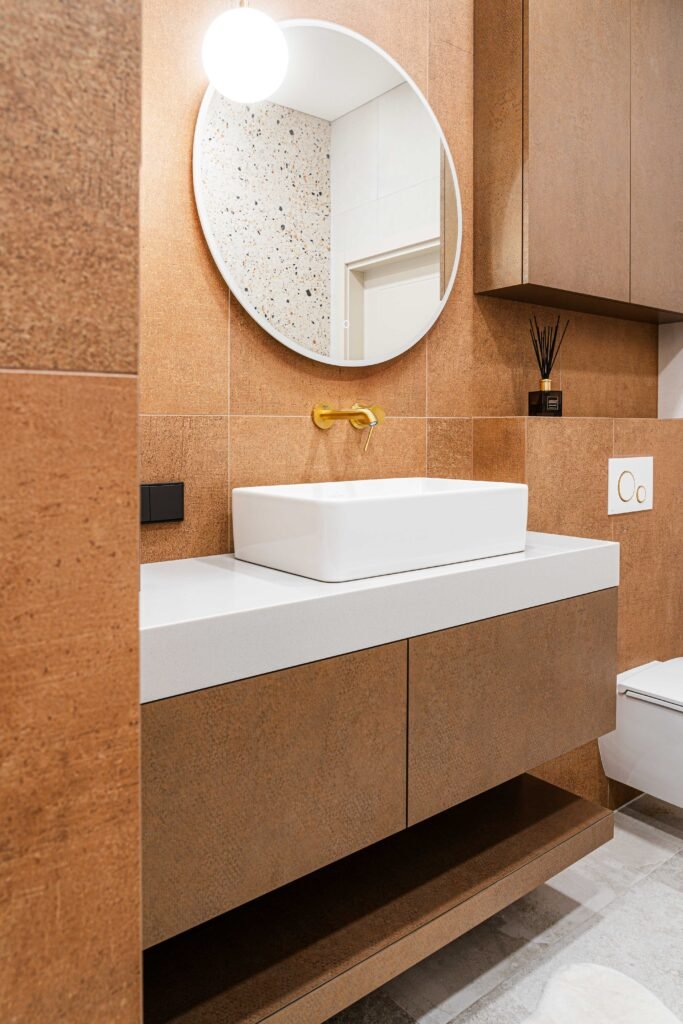 Close-up of white countertop basin and floating vanity against terracotta tiles, AK Interior Design, Cork, Ireland.