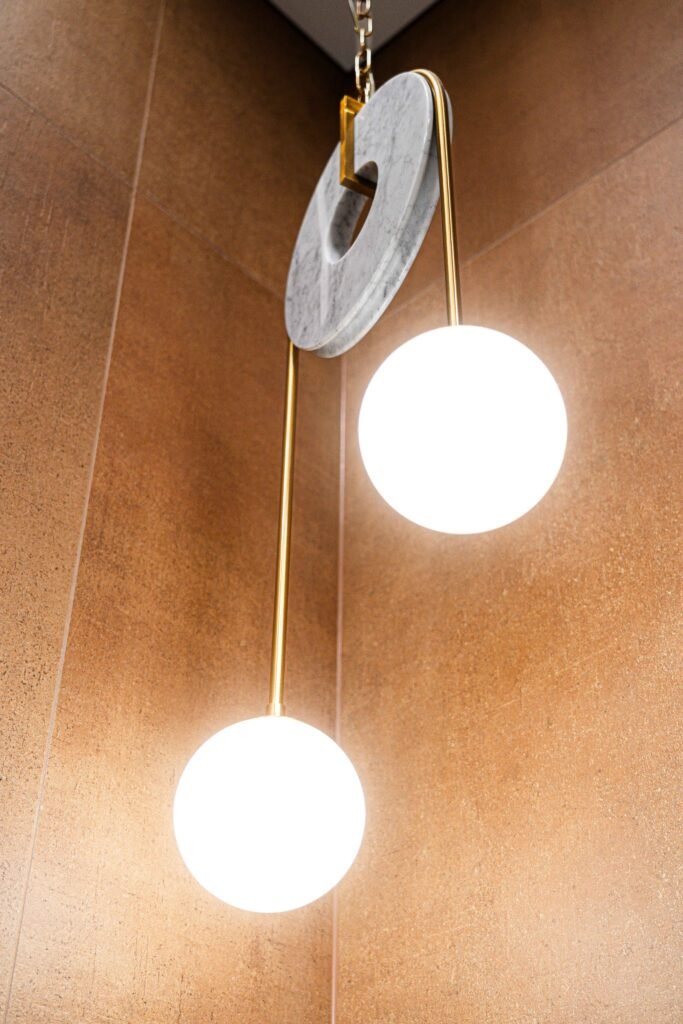 Sculptural marble and gold pendant light with twin globes in bathroom corner, AK Interior Design, Cork, Ireland.