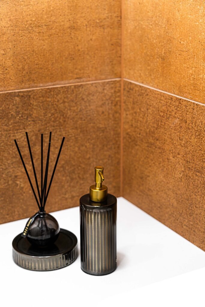 Black reed diffuser and ribbed soap dispenser styled on white vanity top, AK Interior Design, Cork, Ireland.