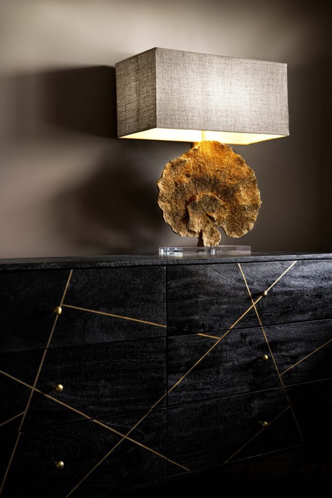 Modern bedside dresser with black wood, gold details and a sculptural table lamp – Monkstown Full House Design by AK Interior.