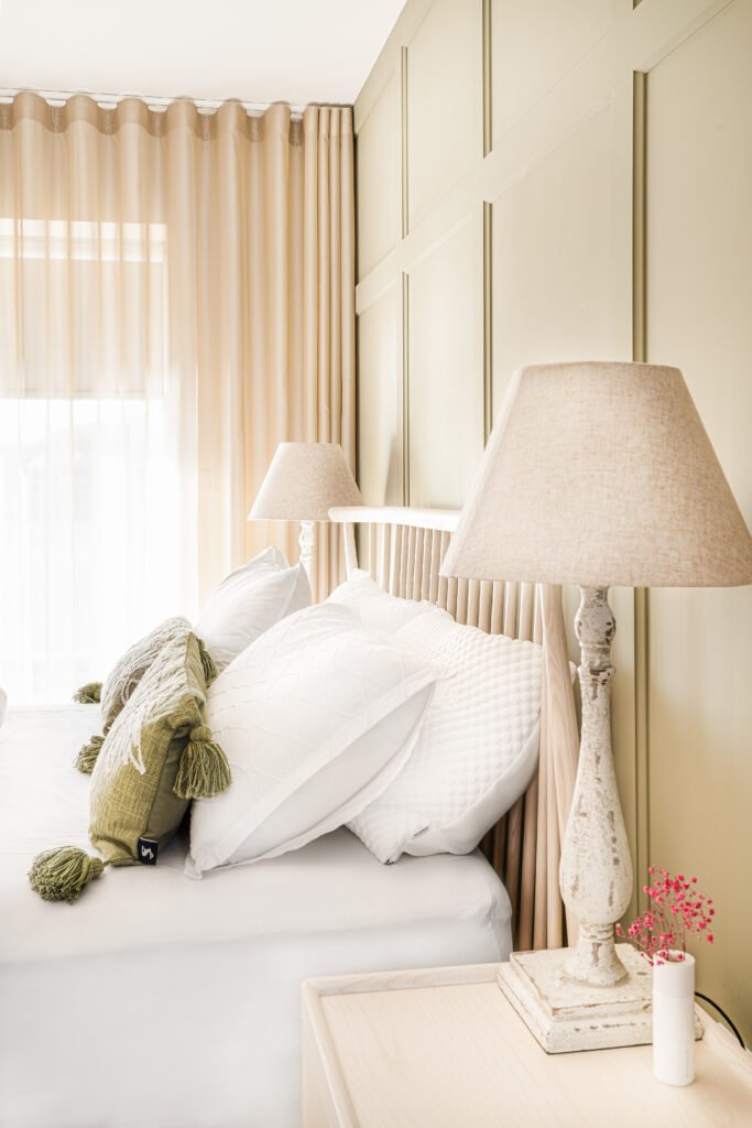 Bedroom corner with white bedside table, lamp and pillow on the bed – West Cork Waterfront, residential project by AK Interior, Cork, Ireland.