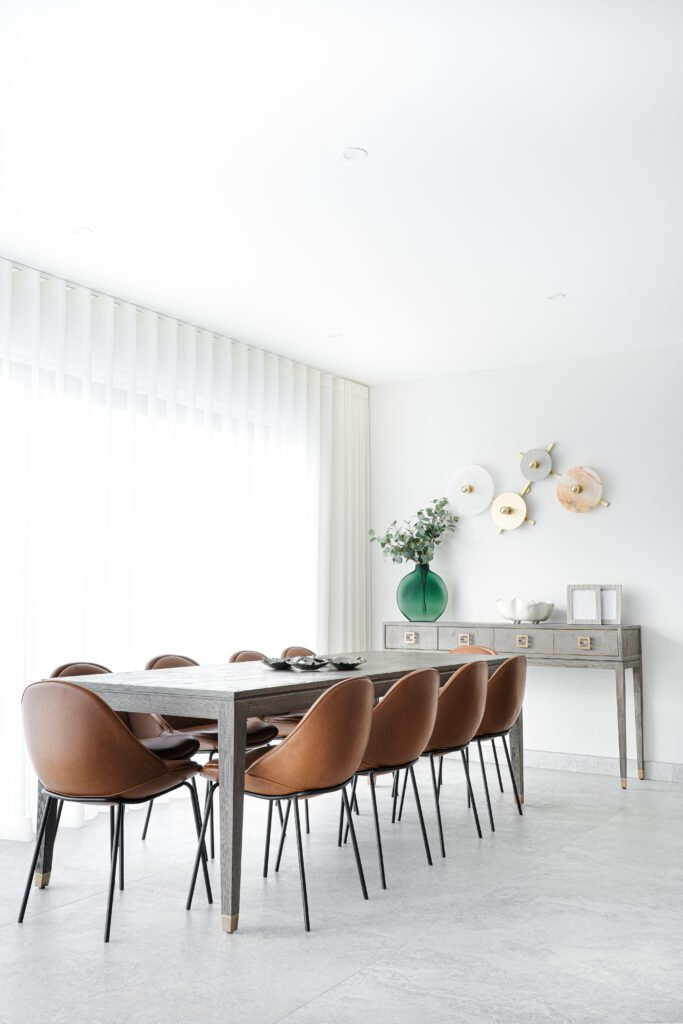 Full view of dining room with floor-to-ceiling sheers and modern chairs. Rosscarbery Residence residential project, AK Interior.