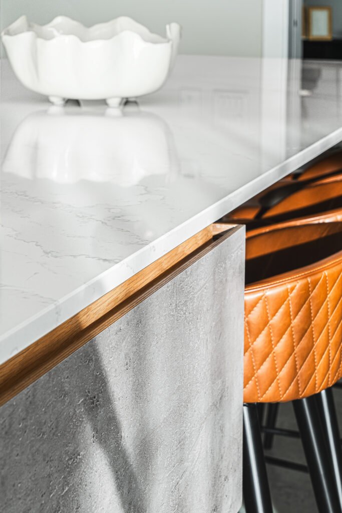 Marble-look worktop with sculptural bowl and stitched leather bar stool. Rosscarbery Residence residential project, AK Interior.