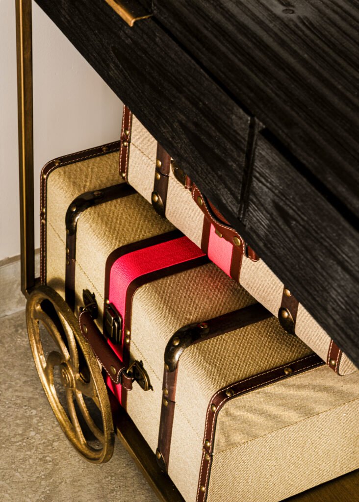 Upholstered storage bench with striped cushions beneath artwork. Rosscarbery Residence residential project, AK Interior.