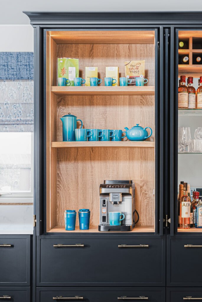 Tall black kitchen cabinet with open wooden shelving and blue accessories – Dingle project, designed by AK Interior, Cork, Ireland.