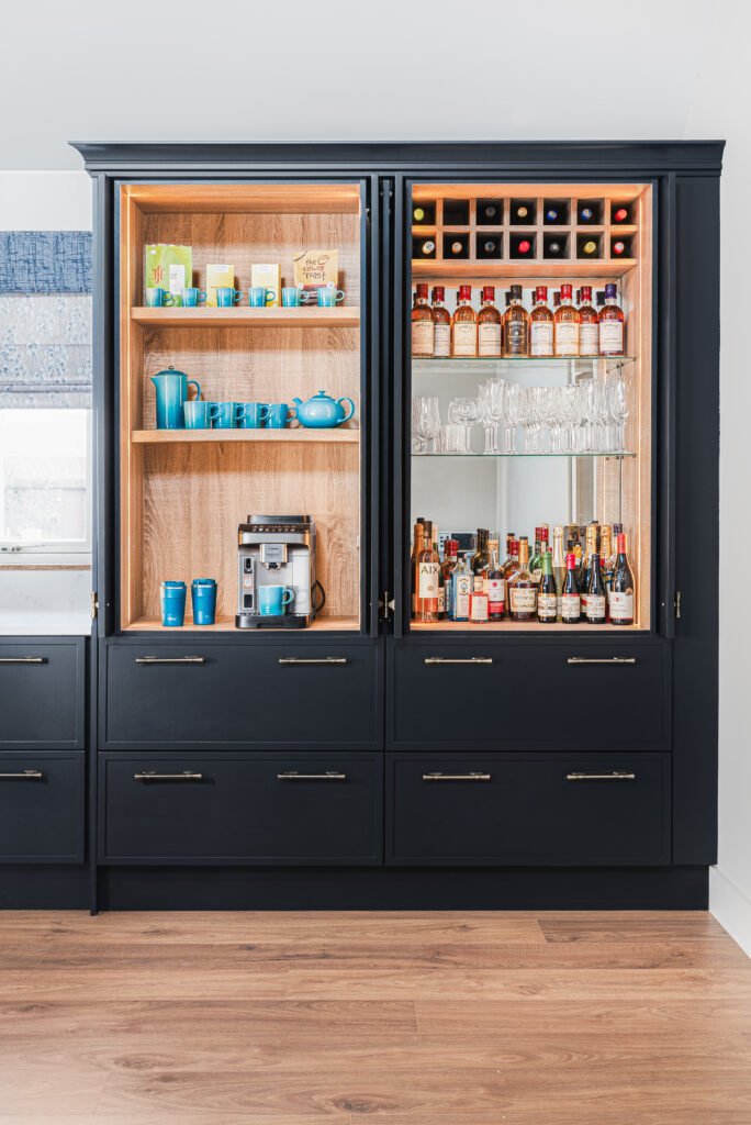 Black kitchen display cabinet with integrated bar setup – Dingle project, designed by AK Interior, Cork, Ireland.