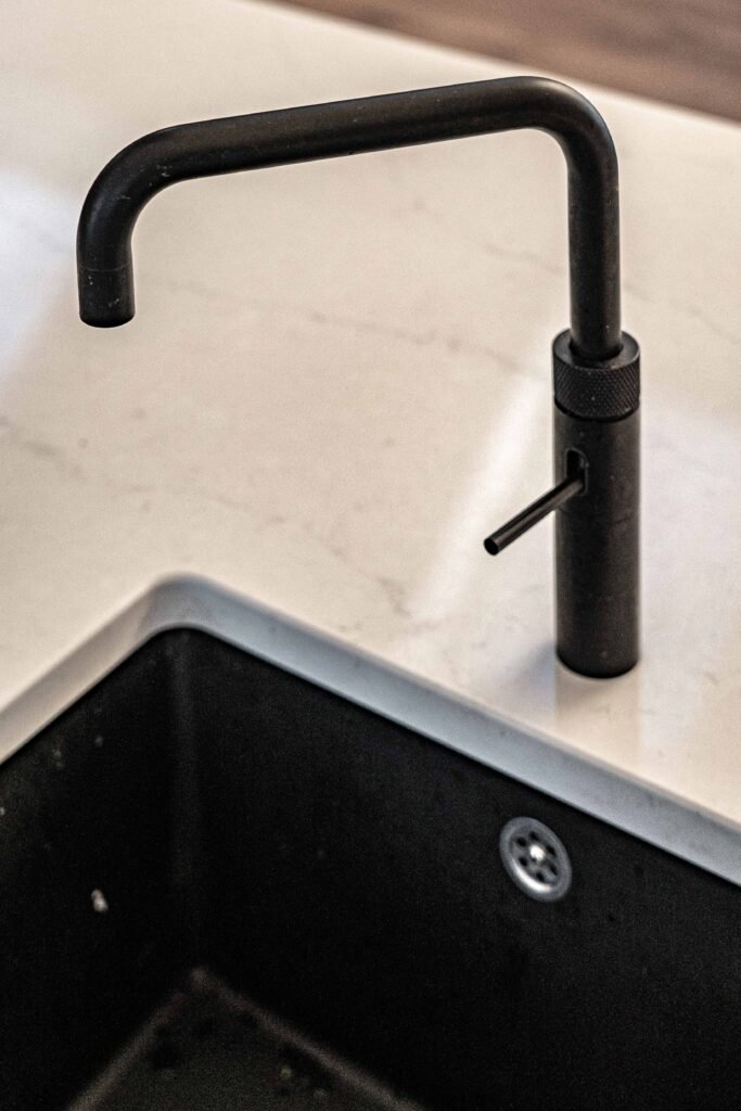Close-up of matte black kitchen tap and countertop – Dingle project, designed by AK Interior, Cork, Ireland.