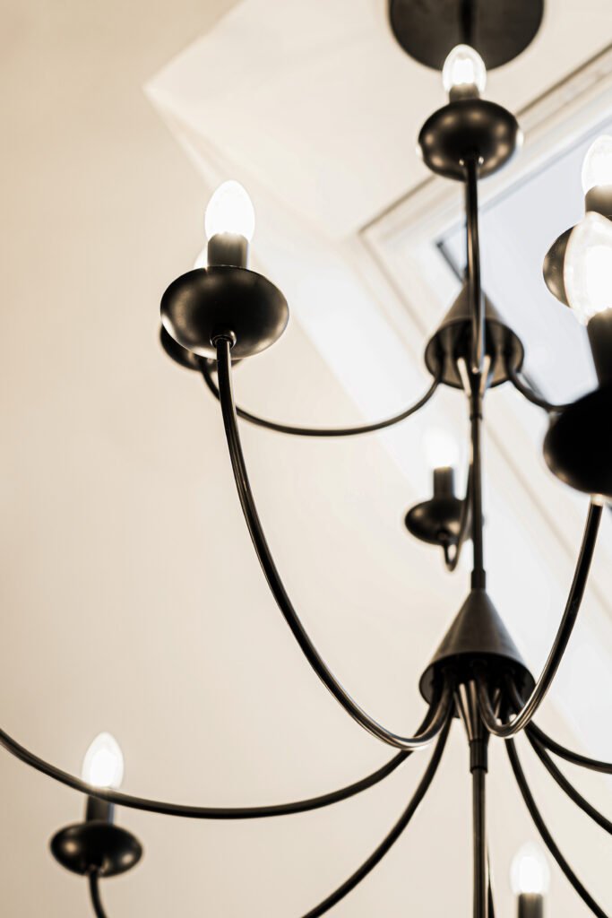 Close-up of sculptural black chandelier in bright dining room – Dingle project, designed by AK Interior, Cork, Ireland.