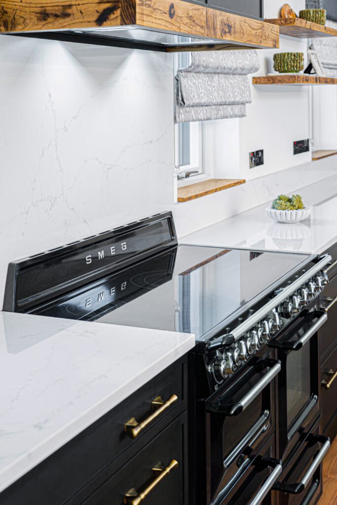 Bright kitchen with black range cooker and marble-effect backsplash – Dingle project, designed by AK Interior, Cork, Ireland.