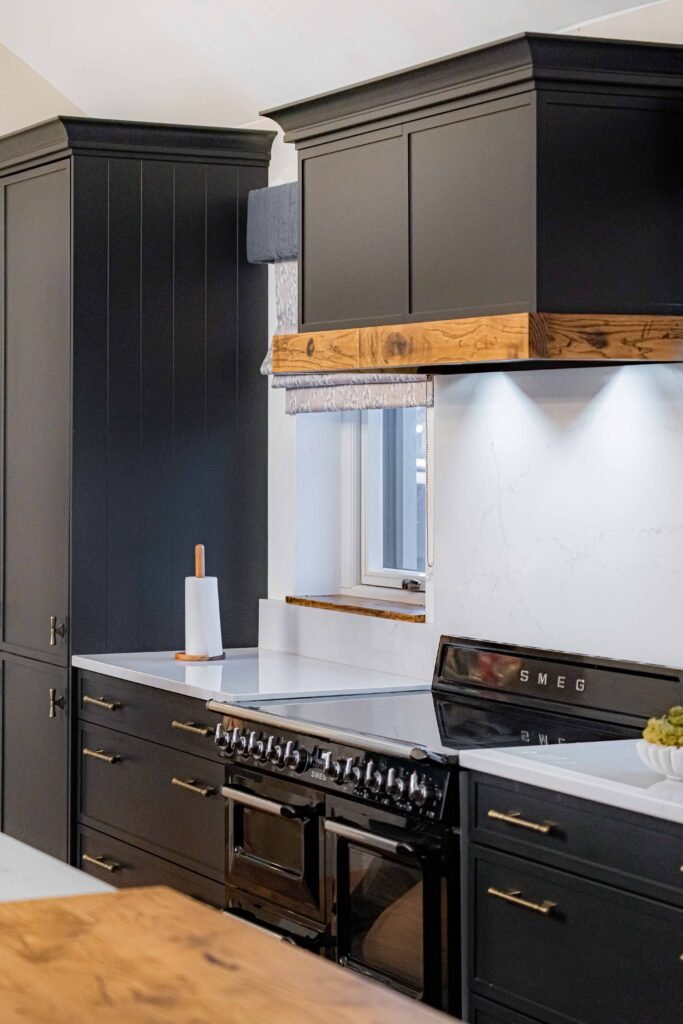 Close-up of black range cooker with brass detailing – Dingle project, designed by AK Interior, Cork, Ireland.