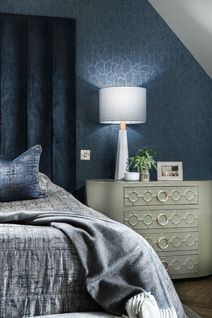 Bedroom corner with grey bed, throw and light chest with modern table lamp – Youghal Residential, AK Interior, Cork