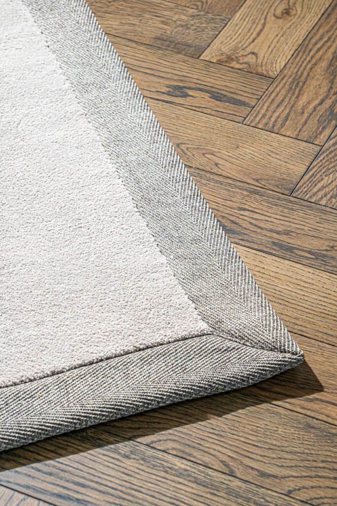 Corner of light rug on herringbone wooden flooring – Youghal Residential, AK Interior, Cork