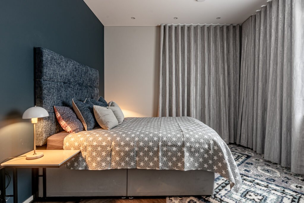 Bedroom with dark blue wall and textured bedding – Monkstown Full House Design – AK Interior