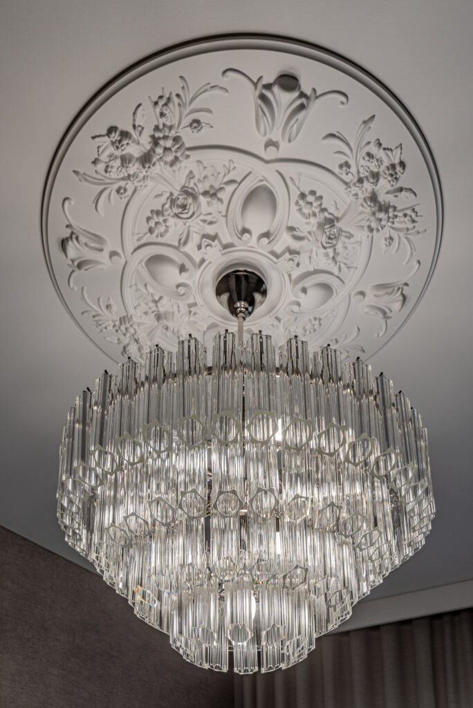 Detailed close-up of a crystal chandelier and decorative ceiling rosette – AK Interior, Monkstown Full House Design