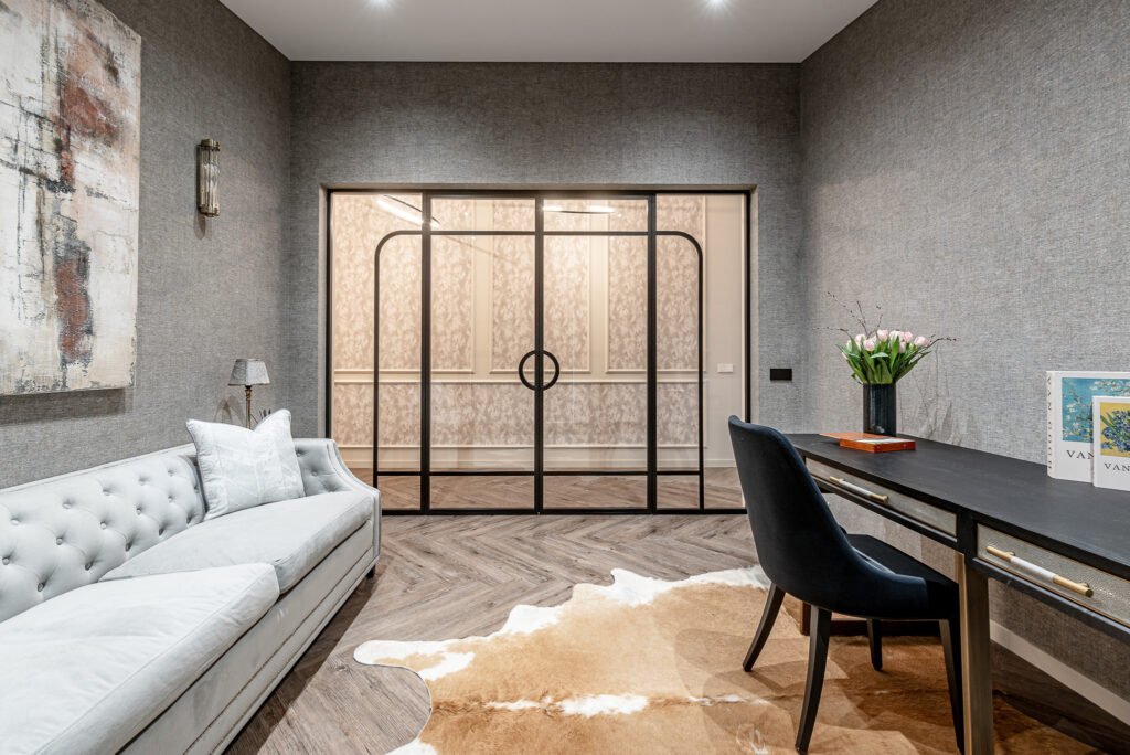 Home office with textured wall, soft beige sofa and glass partition doors – Monkstown Full House Design – AK Interior