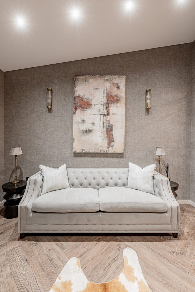 Light beige sofa with cushions and abstract wall art – Monkstown Full House Design – AK Interior