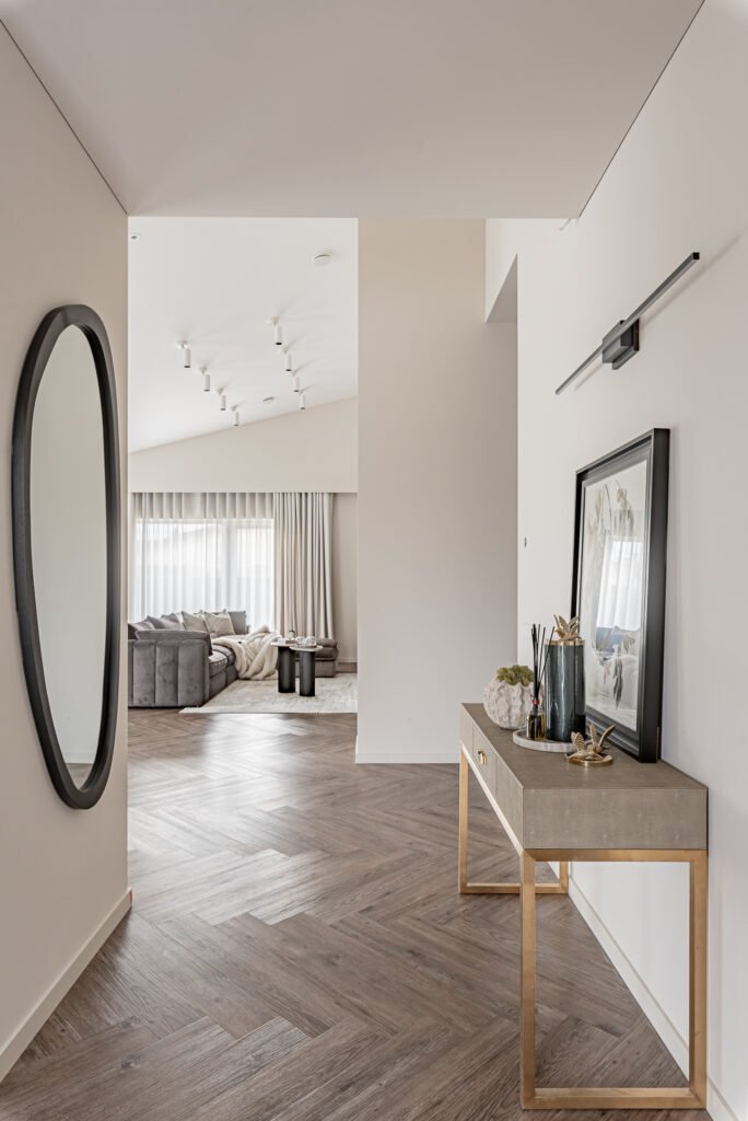 Hallway view with an oval mirror and console table | Monkstown Full House Design | AK Interior