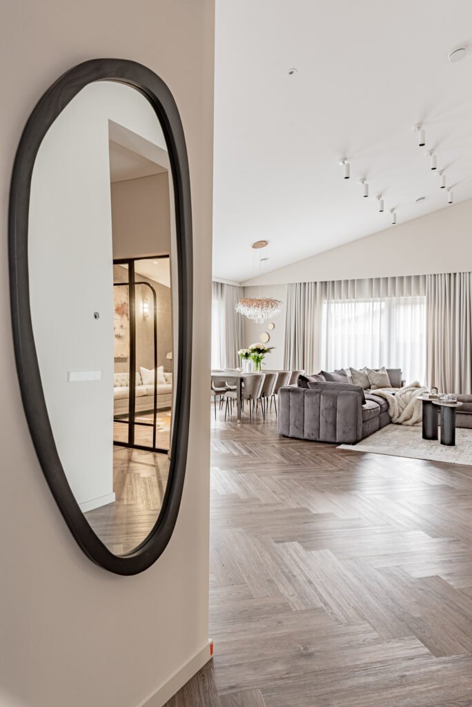 Tall black mirror in the hallway with a view toward the living room. Project Monkstown Full House Design – AK Interior.