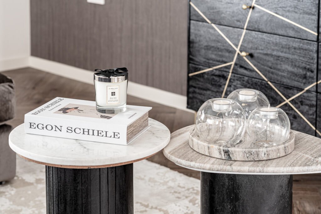 Marble coffee tables styled with candles and decorative glass pieces. Project Monkstown Full House Design – AK Interior.