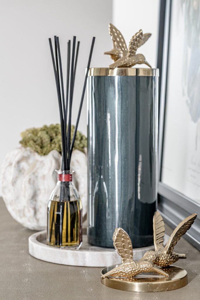 Console table styling with artwork, fragrance diffuser, and sculptural accessories. Project Monkstown Full House Design – AK Interior.