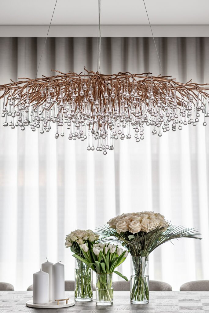 Unique branch-style crystal chandelier above the dining table. Project Monkstown Full House Design – AK Interior.